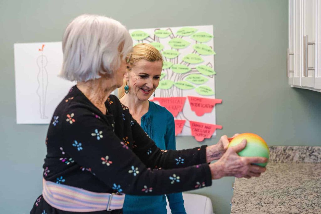 Senior woman and staff member during a physical therapy exercise - Harpers Station Gainesville